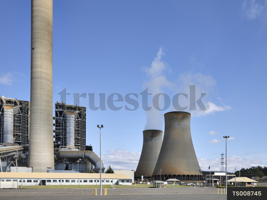 Power station with cooling towers and smoke
