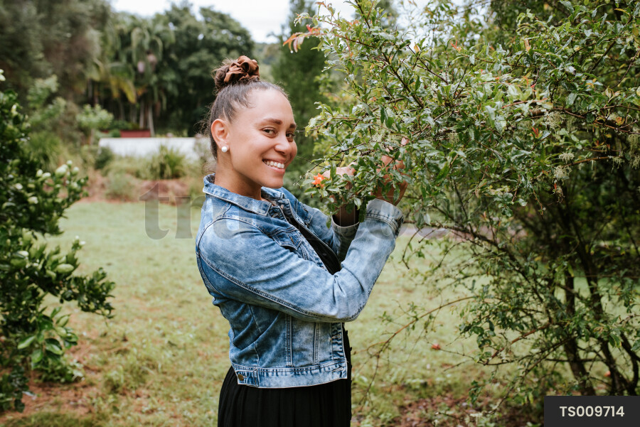 Woman smiling with pomegranate flower