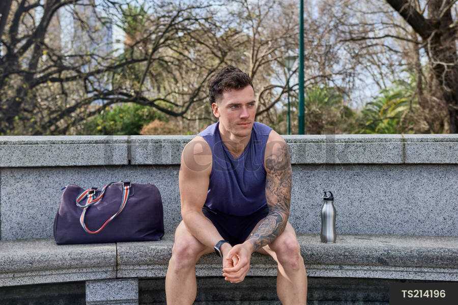 Young Man Sitting on Park Bench