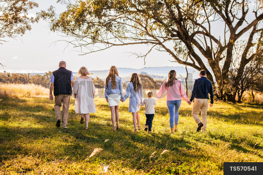 Family walking in field on farm