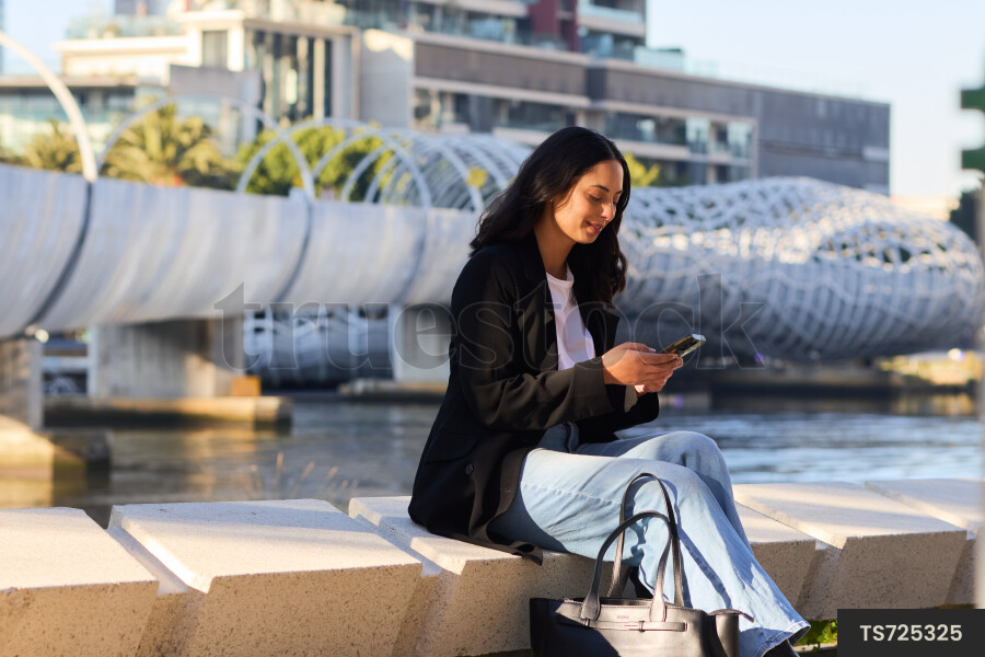 Professional woman text messaging on cell phone