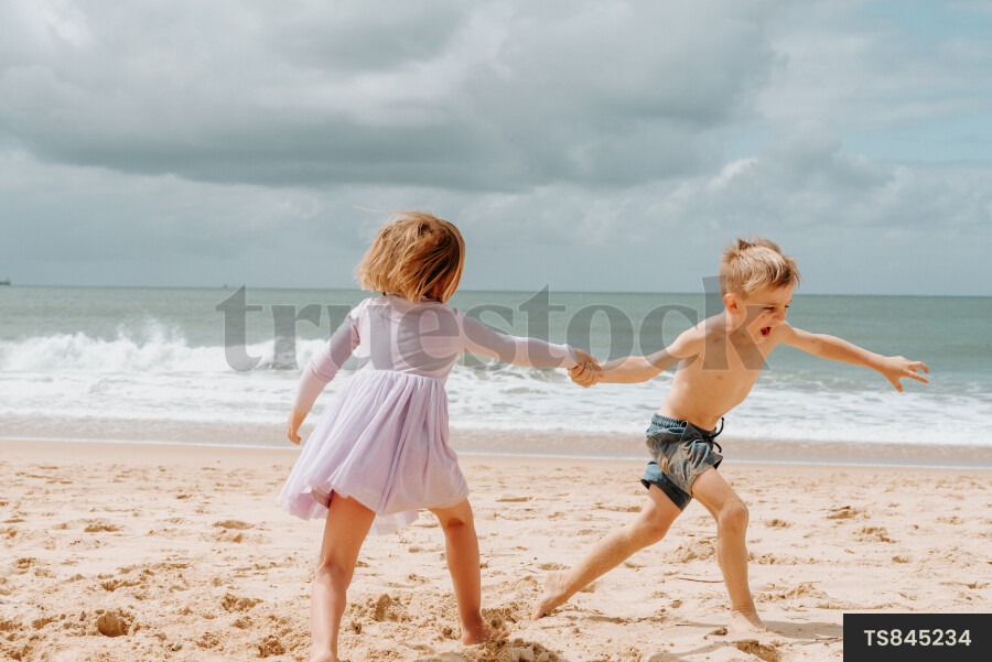 Brother and sister playing on beach