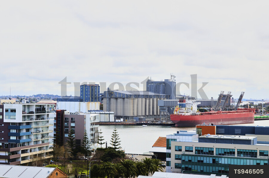 Cargo ship docked at ndustrial area in a coastal city of Newcastle NSW